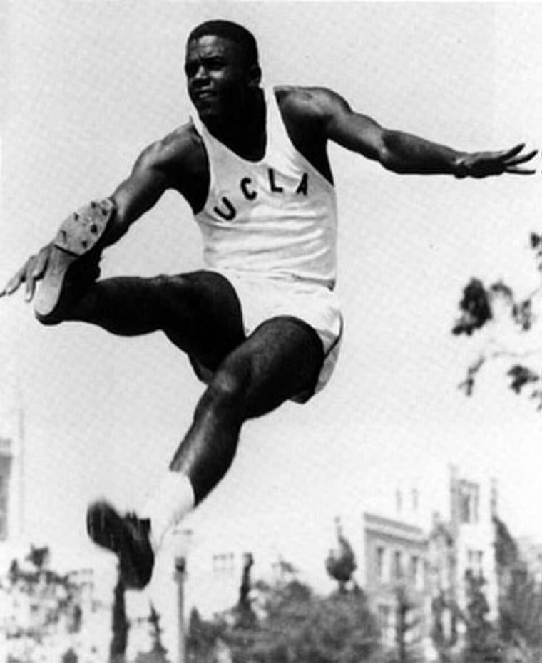 Robinson doing the long jump for UCLA